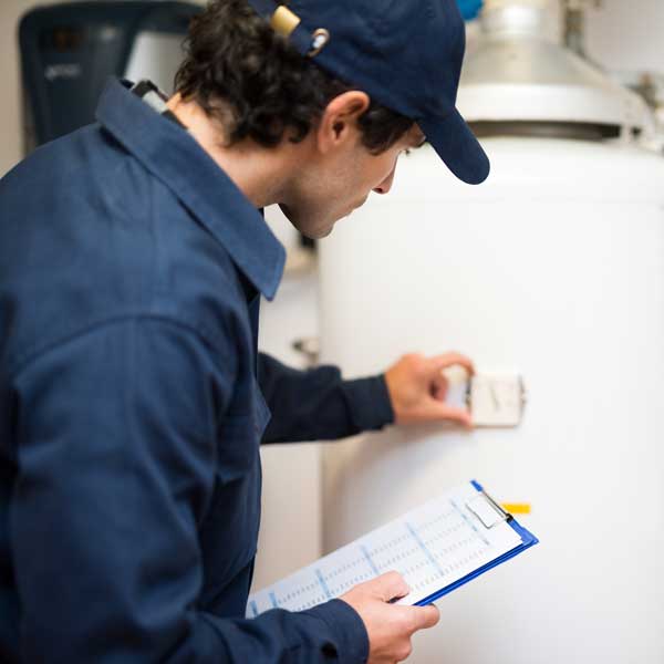 technician repairing hot water heater